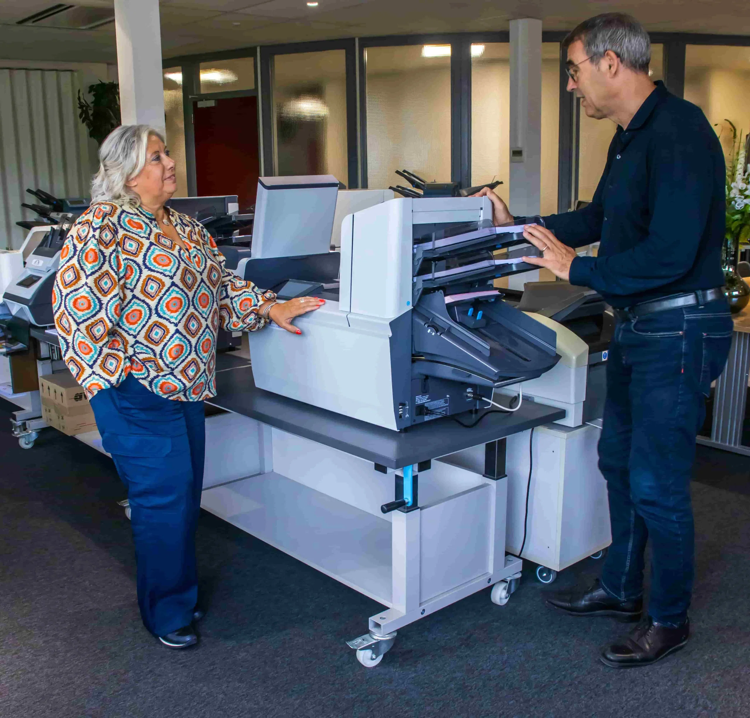 Twee personen bij een vouwmachine